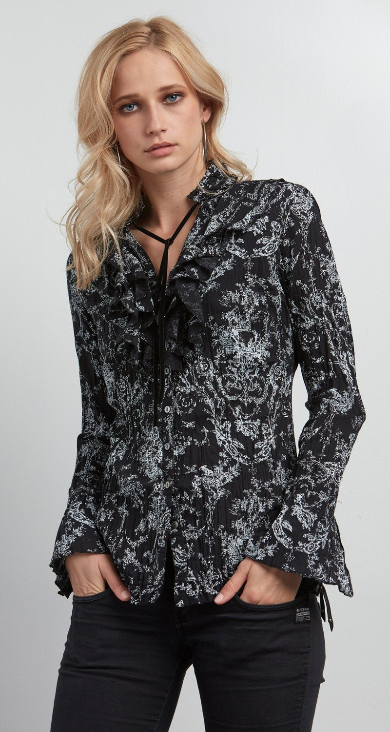 A model wears a CINO Vintage Toile Black button-down ruffle shirt.