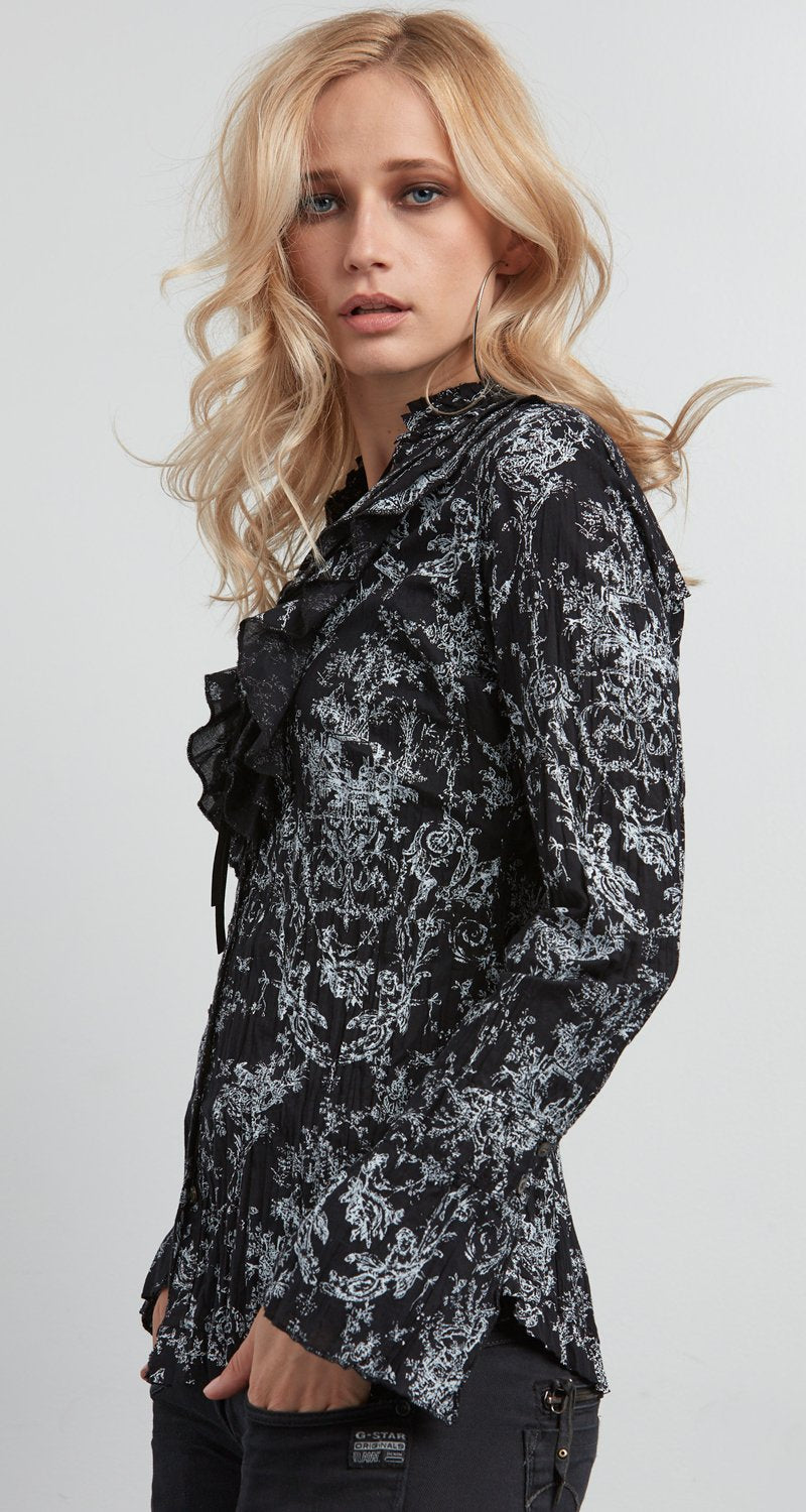 A model wears a CINO Vintage Toile Black button-down ruffle shirt.