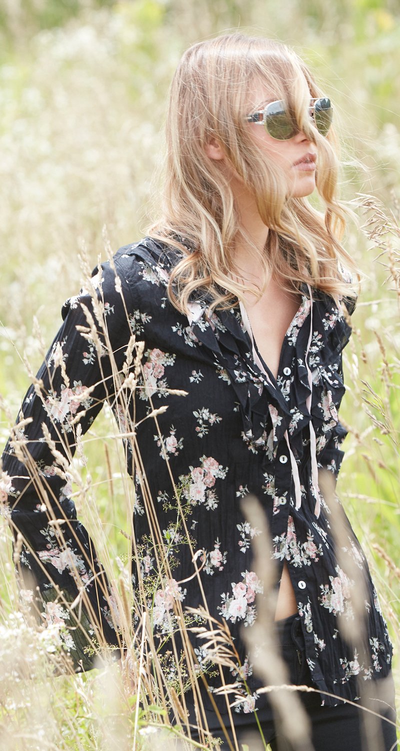 A model wears a CINO  Vintage Rose Black button-down ruffle shirt.