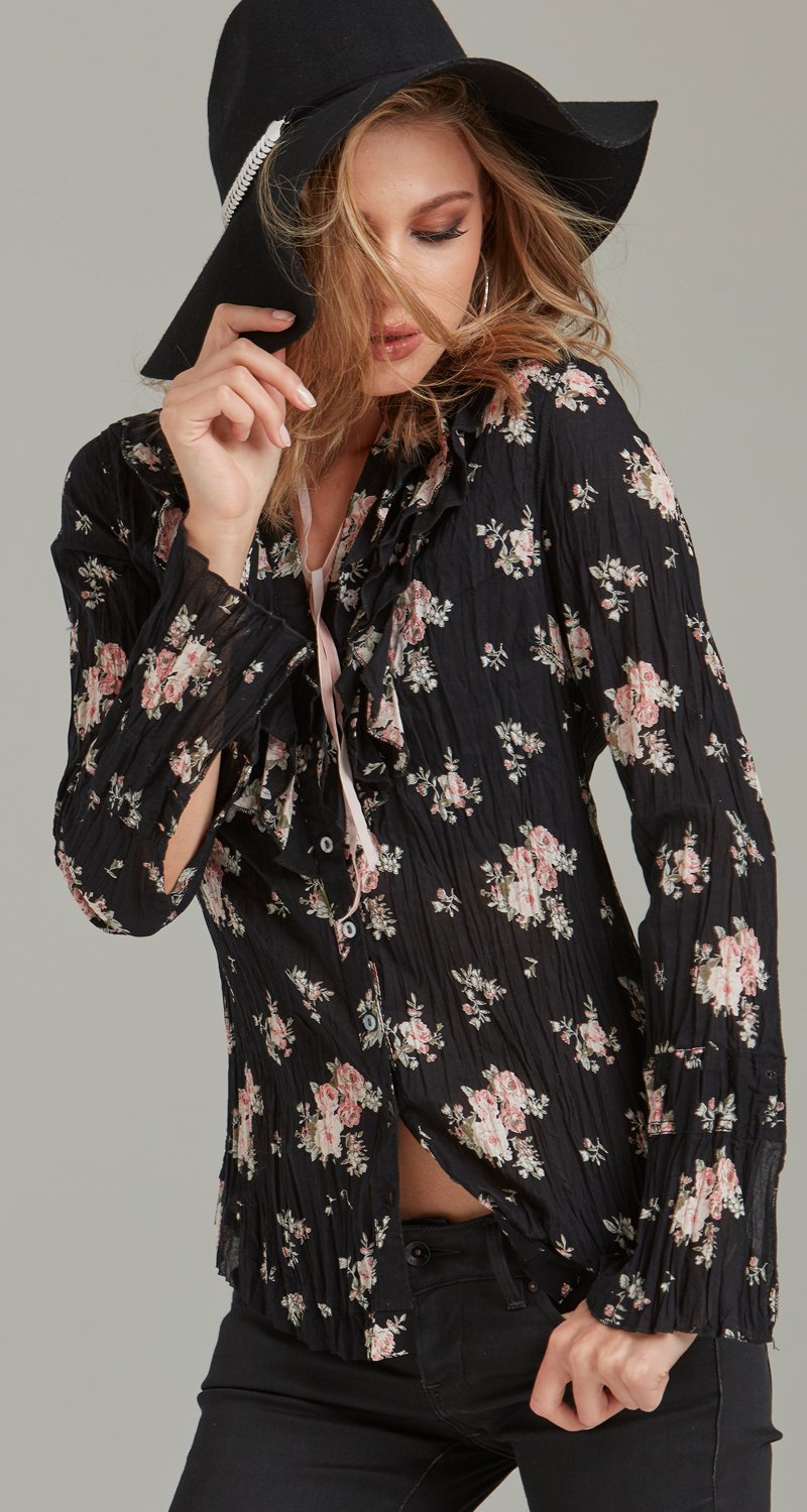 A model wears a CINO  Vintage Rose Black button-down ruffle shirt.